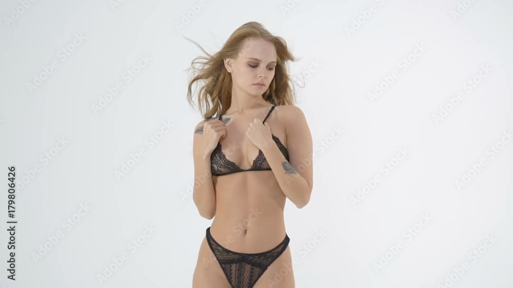 Young and beautiful fashion model posing in erotic lingerie over white background. Fashion, beauty, glamour concept. Young and beautiful fashion model posing in erotic lingerie over white background. Fashion, beauty, glamour concept.