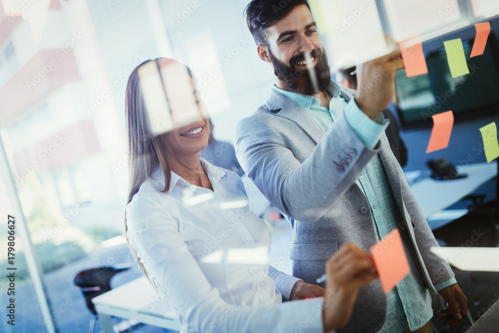 Picture of designers sticking notes in office Picture of designers sticking notes in office