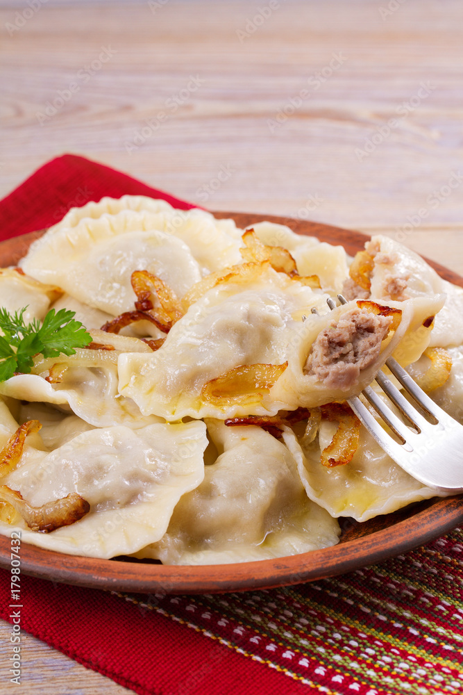 Dumplings, filled with meat and served with salty caramelized onion. Varenyky, vareniki, pierogi, pyrohy. Dumplings with filling, vertical Dumplings, filled with meat and served with salty caramelized onion. Varenyky, vareniki, pierogi, pyrohy. Dumplings with filling, vertical