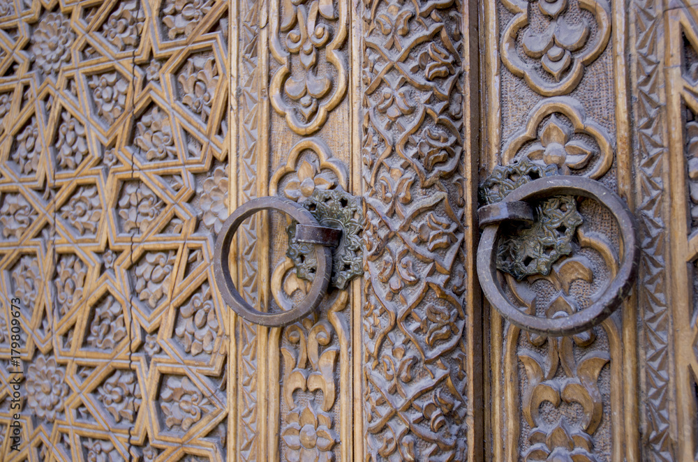 An old wood door with metal handle. Details of Muslim architecture.