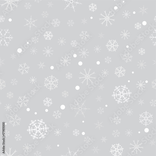 seamless pattern from white snowflakes on the grey background. Texture for cards  greeting  Christmas  new year  holiday  party