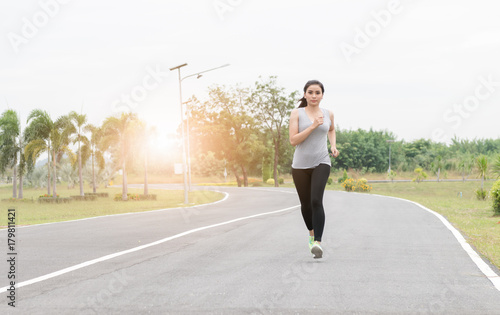 Running woman. Female runner jogging at health park