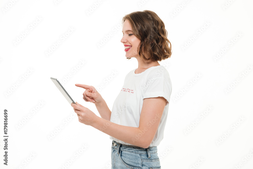Portrait of a smiling young girl using tablet computer Portrait of a smiling young girl using tablet computer