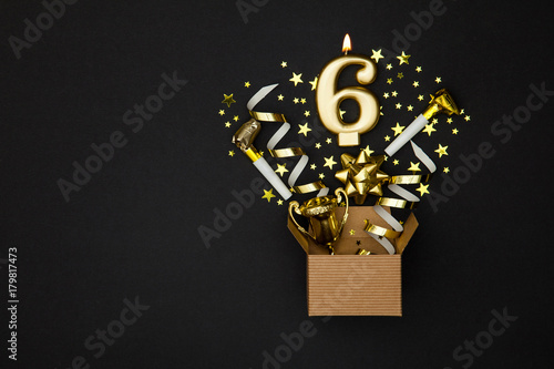 Number 6 gold celebration candle and gift box background