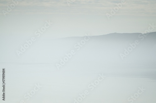 The coast of the arctic island in the fog photo