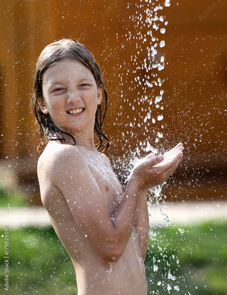 Obraz premium Boy with Blond Hair Washing at Outdoor Shower