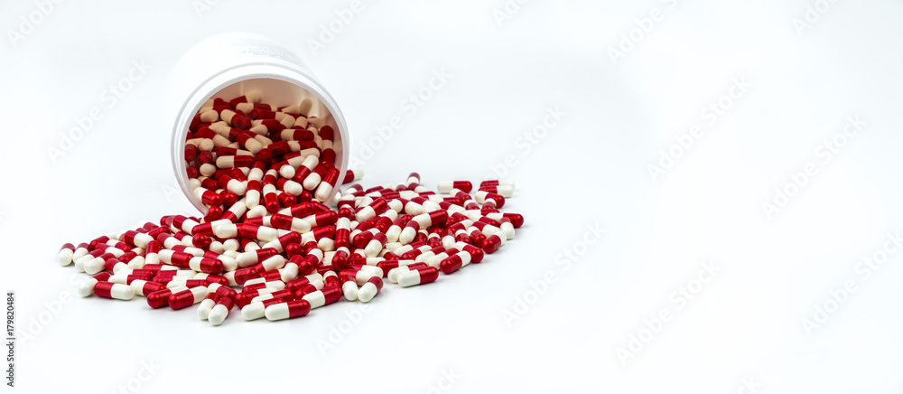 Colorful of antibiotic capsules pills with plastic bottle on white background. Drug resistance, antibiotic drug use with reasonable, health policy and health insurance concept. Colorful of antibiotic capsules pills with plastic bottle on white background. Drug resistance, antibiotic drug use with reasonable, health policy and health insurance concept.