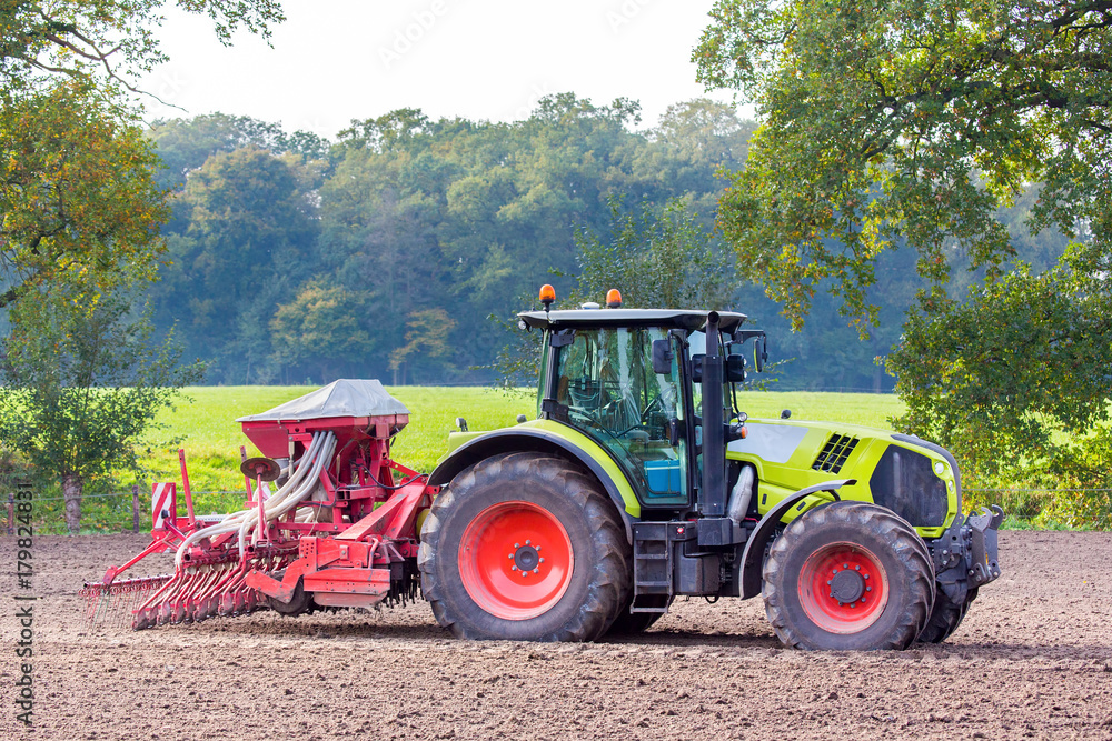 Tractor with agricultural machine on land Tractor with agricultural machine on land