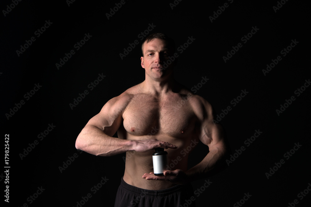 Man with muscular body hold pill jar, sport.