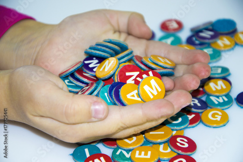 Wallpaper Mural little child girl hand play and learn magnetic alphabets on board Torontodigital.ca