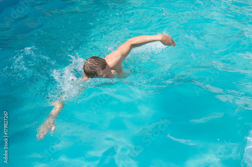 Man swims in the pool. 