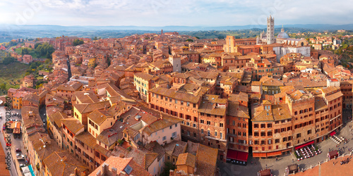 Beautiful aerial panoramic view of Siena Cathedral, Duomo di Siena, and Old Town of medieval city of Siena in the sunny autumn day, Tuscany, Italy