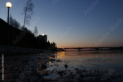 Fototapeta Naklejka Na Ścianę i Meble -  Sunset over the bridge on the river at the evening
