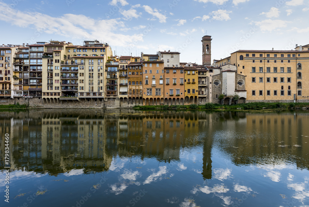 Florence cityscape view reflex to the Arno River.
