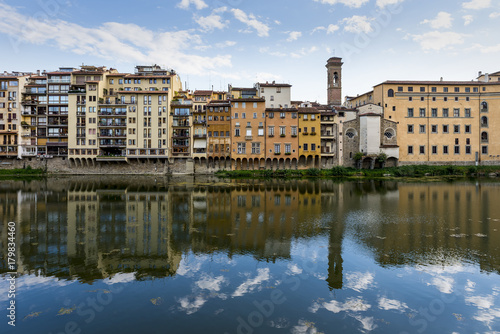 Florence cityscape view reflex to the Arno River.