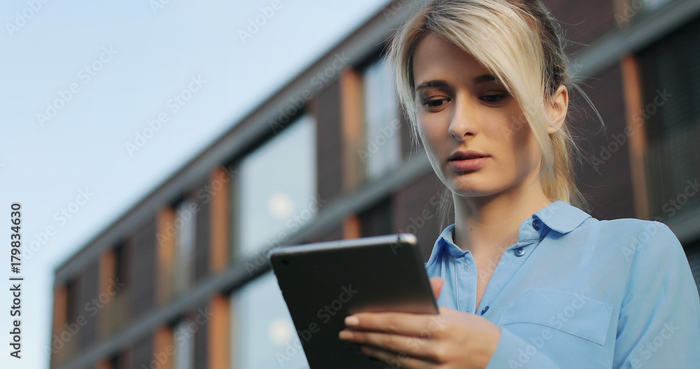 Woman using digital tablet PC in the park. Woman using digital tablet PC in the park.