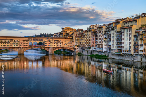 Florence cityscape view with Ponte Vecchio, a medieval stone bridge over Arno River.