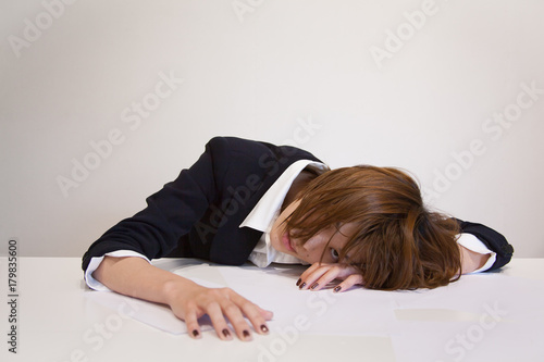 Tired Japanese Office Worker at Workplace