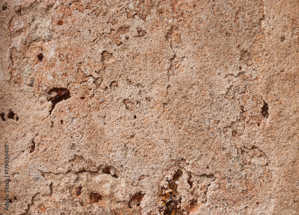 Textures of weathered stone wall background of the ancient city.