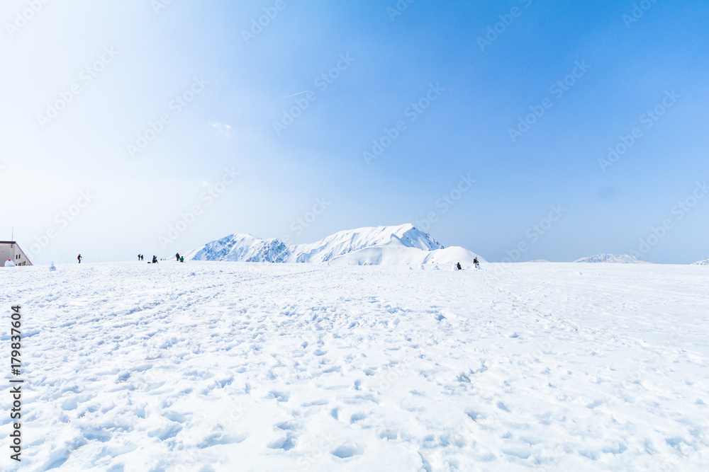 The snow mountains of Tateyama Kurobe alpine with blue sky background is one of the most important and popular natural place in Toyama Prefecture, Japan. The snow mountains of Tateyama Kurobe alpine with blue sky background is one of the most important and popular natural place in Toyama Prefecture, Japan.