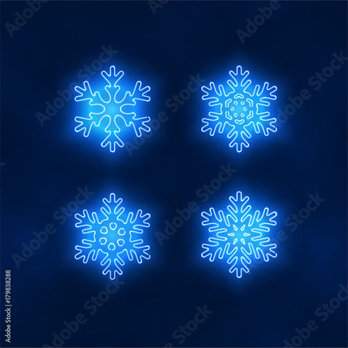 Set of vibrant blue radiating neon snowflakes