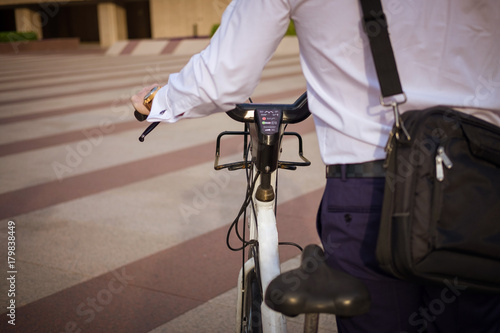 Young buinessman riding to work in the city