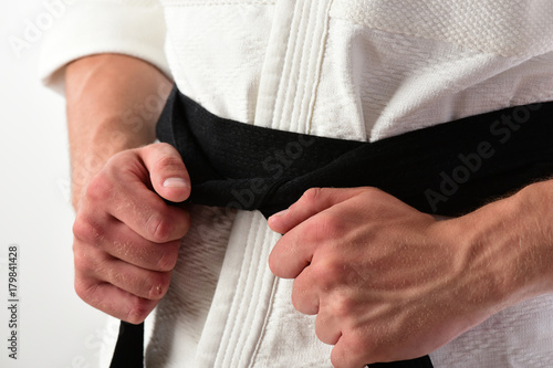 Karate fighter with fit strong hands gets ready to fight