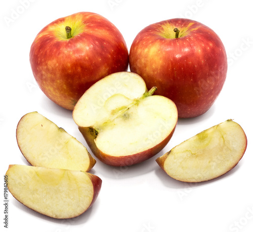 Two whole Kanzi apples, one half, three slices, isolated on white background photo