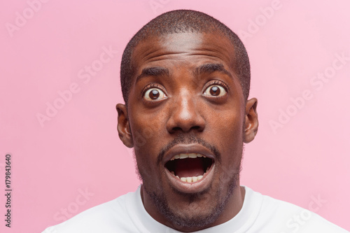 The portrait of handsome young surprised black african man