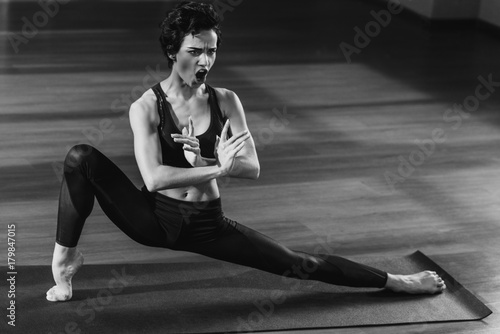 shouting woman stretching on yoga mat