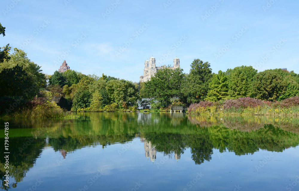 Turtle Pond, Central Park, surrounded by trees and lush plants