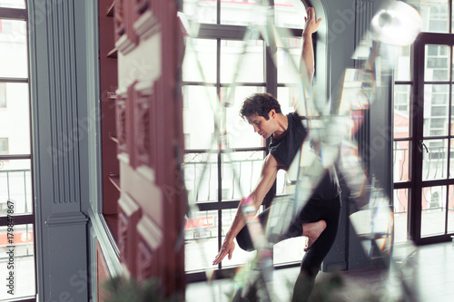 Man performing yoga indoors photo