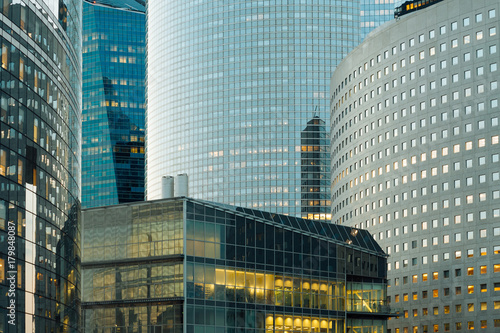Fototapeta Naklejka Na Ścianę i Meble -  Modern buildings in Paris business district La Defense. Night cityscape with glass facades of skyscrapers. City lights, urban architecture, contemporary city life. Economy, financial activity concept
