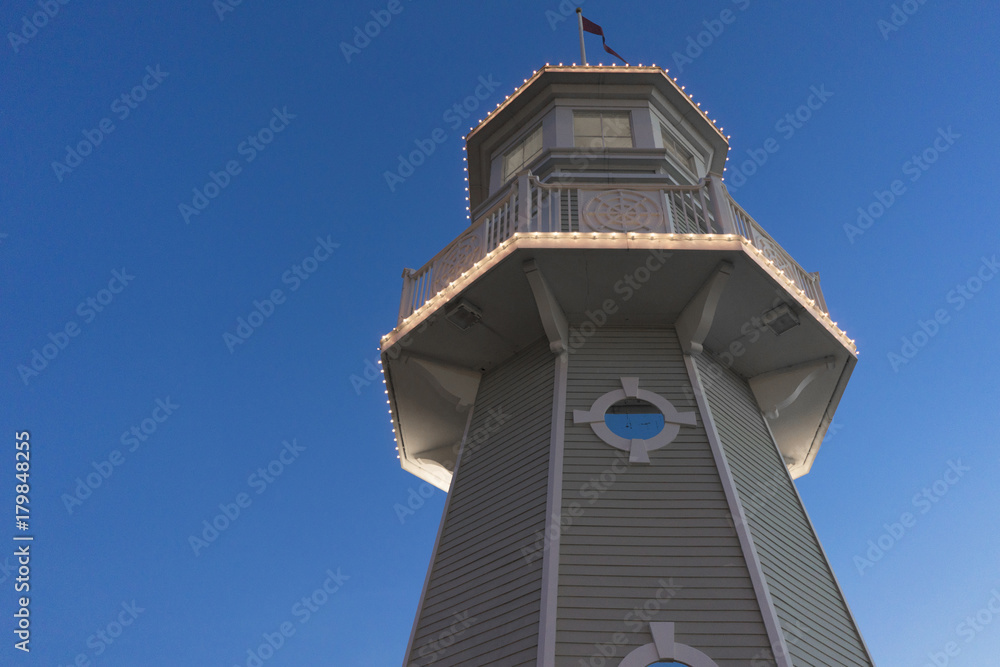 A Lighthouse At Night With A Blue Sky