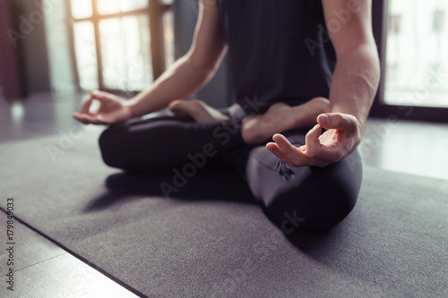 Close up hands of man doing yoga lotus pose