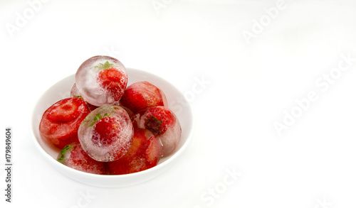 Ice cubes with frozen strawberries