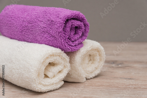 Multicolored towels on a wooden background