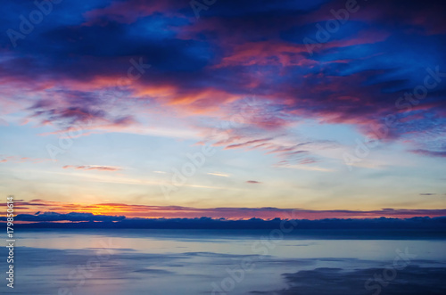 Beautiful red sunset over the lake with mountain © kuzenkova