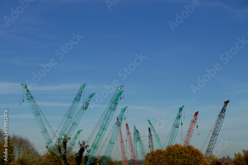 Rural Industrial mix with Cranes against Autumn Sky