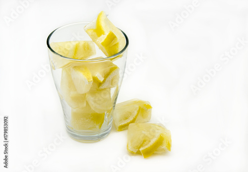 Ice cubes with frozen lemons