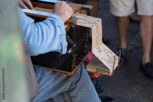 Bilde på lerret Street Musician plays Wooden Barrel Organ with Perforated Cardbo