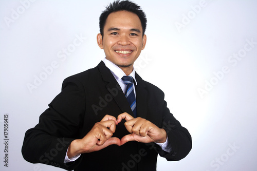 Asian young businessman making a heart with his hands. I love. Business concept