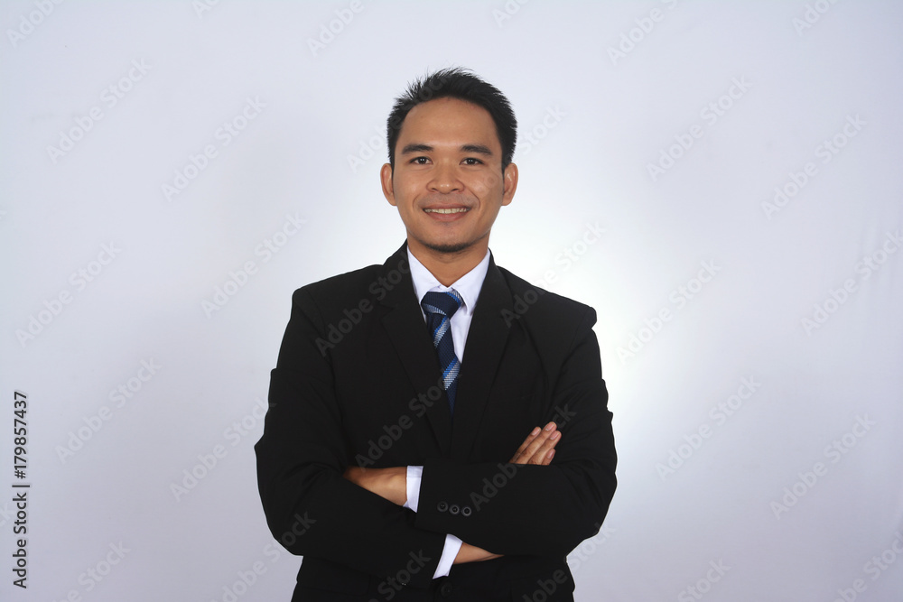 Friendly and smiling Asian businessman looking at camera Friendly and smiling Asian businessman looking at camera
