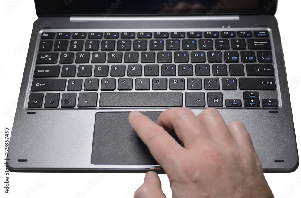 The hand controls the cursor on the laptop keyboard, isolated The hand controls the cursor on the laptop keyboard, isolated