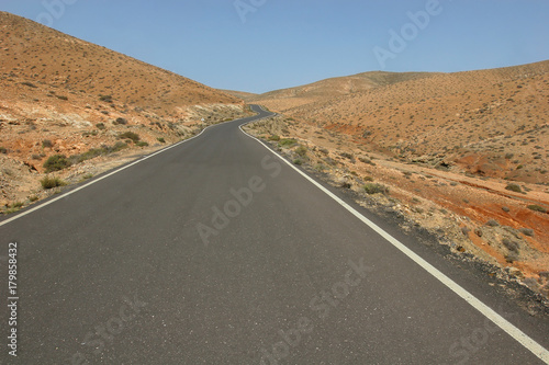 Picturesque road through volcanic desert in Fuerteventura island, Canary Islands, Spain