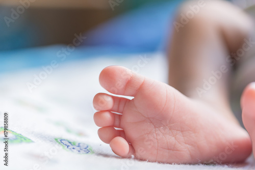 Closeup foot of asian baby on the bed