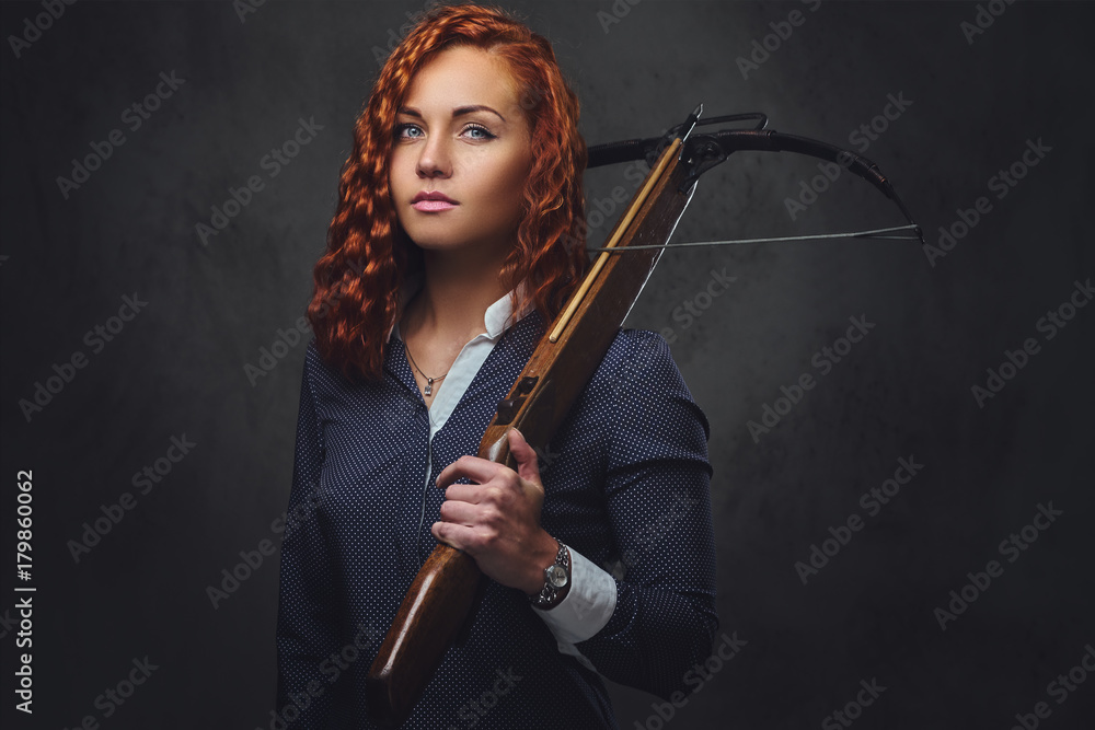 Redhead female holds crossbow. Redhead female holds crossbow.