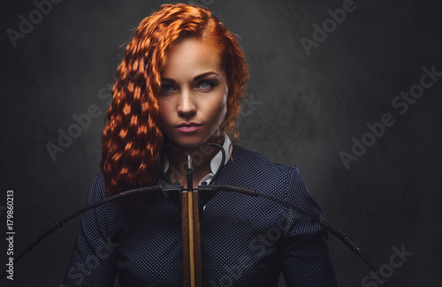 Redhead female  holds cross...