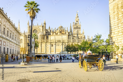 Cathedral of Saint Mary of the See with tourists, Seville, Spain