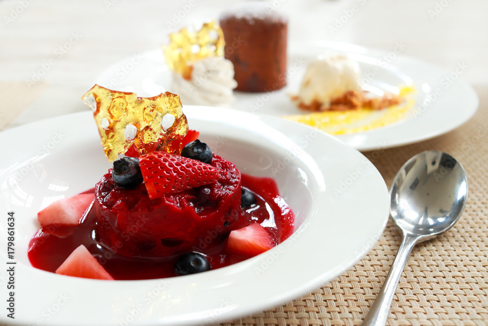 Premium Red velvet cake chocolate lava with fresh strawberry and blueberry  on white dish for celebration event. 